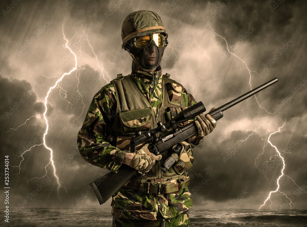 Armed soldier standing in rainy obscure weather
Armed soldier standing in rainy obscure weather