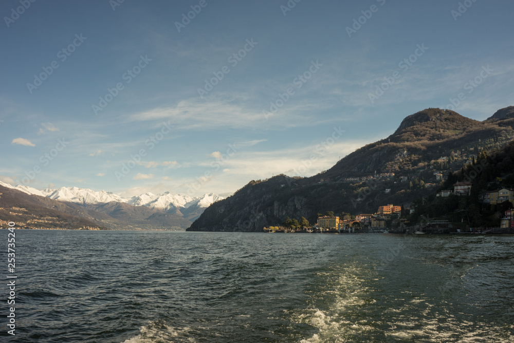 Italy, Bellagio, Lake Como, a large body of water with a snow alps in the background