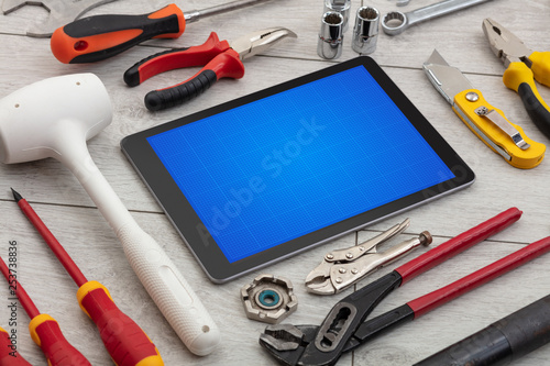 Household tools and tablet with grid screen concept 