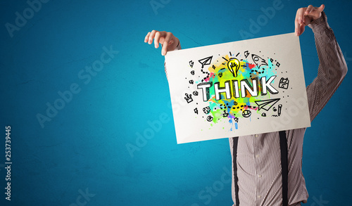 Young person holding paper with design thinking concept 
