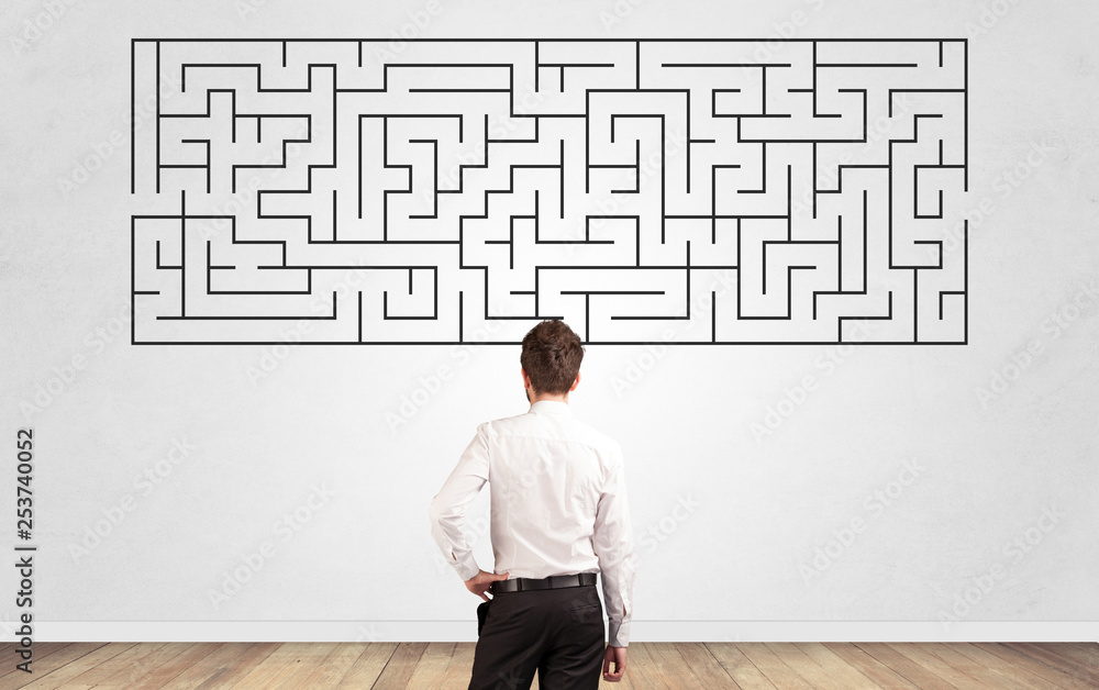Businessman in doubt looking to a maze and searching the way out Businessman in doubt looking to a maze and searching the way out