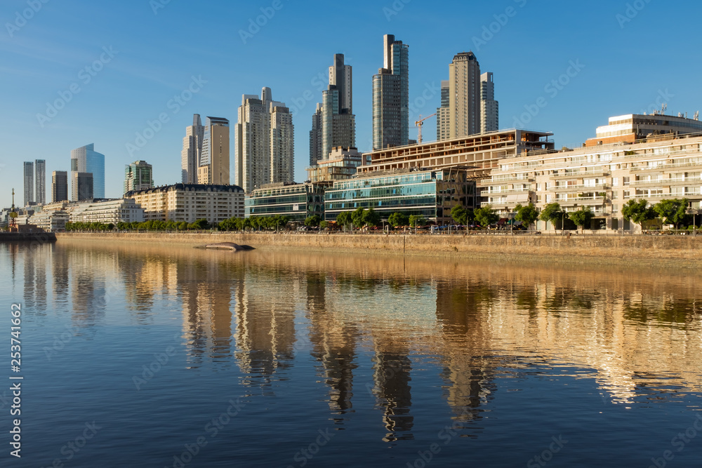 Obraz premium Sweeping view along the Rio de la Plata of the Perto Madero district of Buenos Aires, Argentina with reflections of the modern buildings in the river