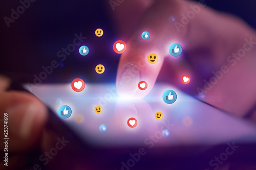 Finger touching phone with social media concept and dark background
