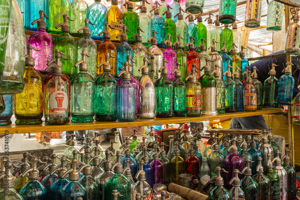 Rows of coloured glass antique soda bottles lined up at a flea market in San Telmo, Buenos Aires, Argentina Rows of coloured glass antique soda bottles lined up at a flea market in San Telmo, Buenos Aires, Argentina