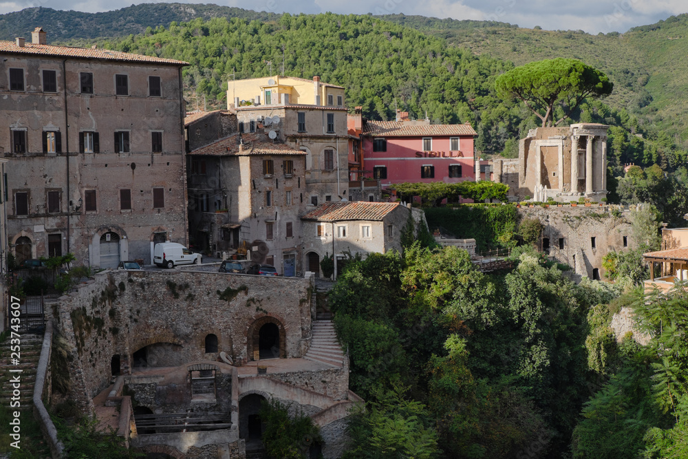 Fototapeta premium TIVOLI, ITALY - 5 OCTOBER 2018: The view of ancient buildings, Vesta temple and stairs with mountains and pine trees in the background.