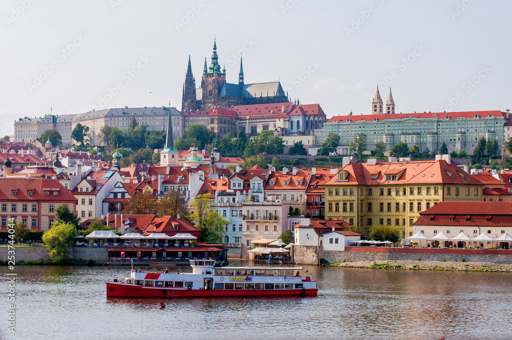 Obraz premium View of the old town and Prague Castle. The ship sails along the Vltava River in Prague, Czech Republic - August 28, 2018