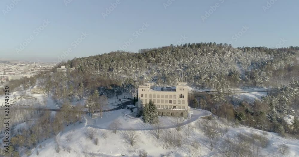 4K high angle aerial view of a beautiful snow covered forrest on Ekeberg, a popular park and recreational area in Oslo, and an old building used to train sailors before going out to sea. 4K high angle aerial view of a beautiful snow covered forrest on Ekeberg, a popular park and recreational area in Oslo, and an old building used to train sailors before going out to sea.