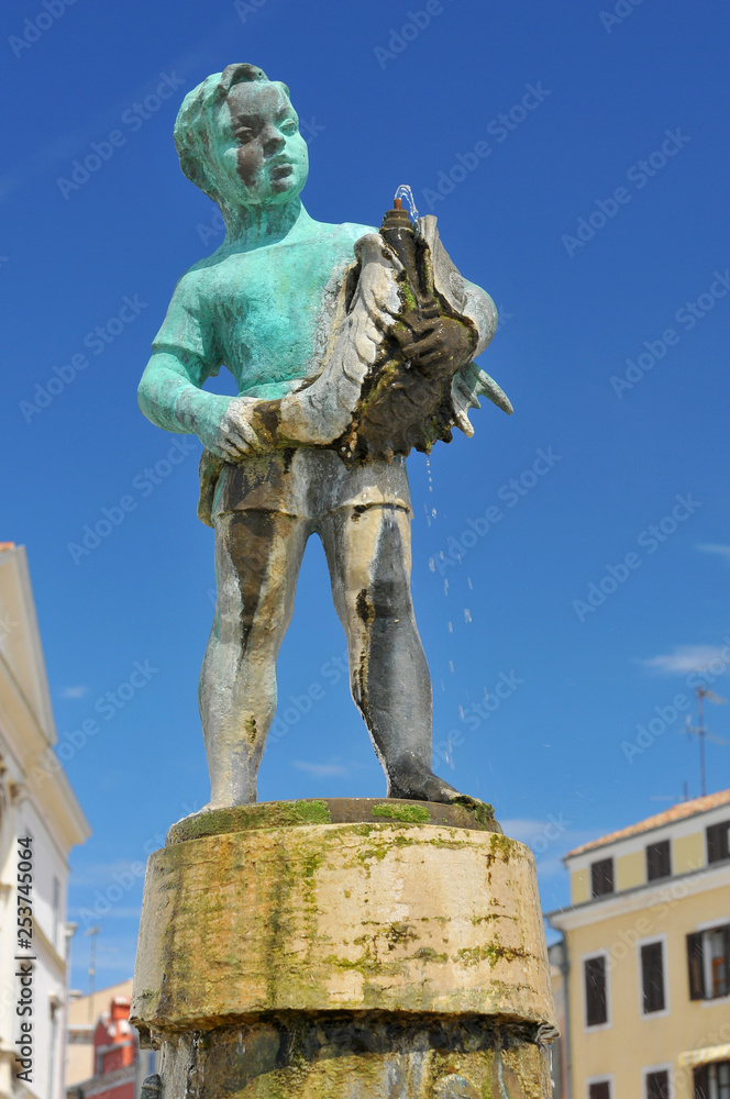 Croatia, Istria, Rovinj, Boy with the fish Fountain on Main Square, Rovinj.