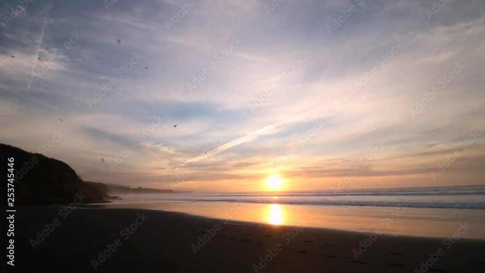Dramatic sunset off the coast in the Pacific, reflected in the ocean. LONG SHOT Dramatic sunset off the coast in the Pacific, reflected in the ocean. LONG SHOT