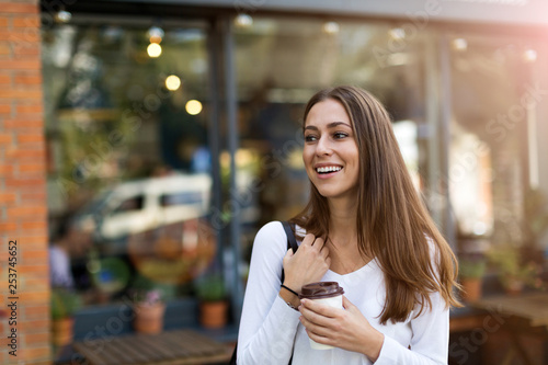 Young woman standing in front of coffee shop