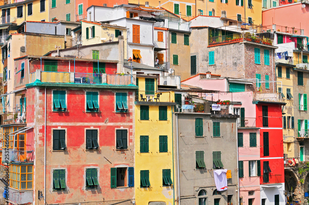 The colorful houses of the fishing port of Riomaggiore, Cinque Terre National Park, Liguria, Italy.