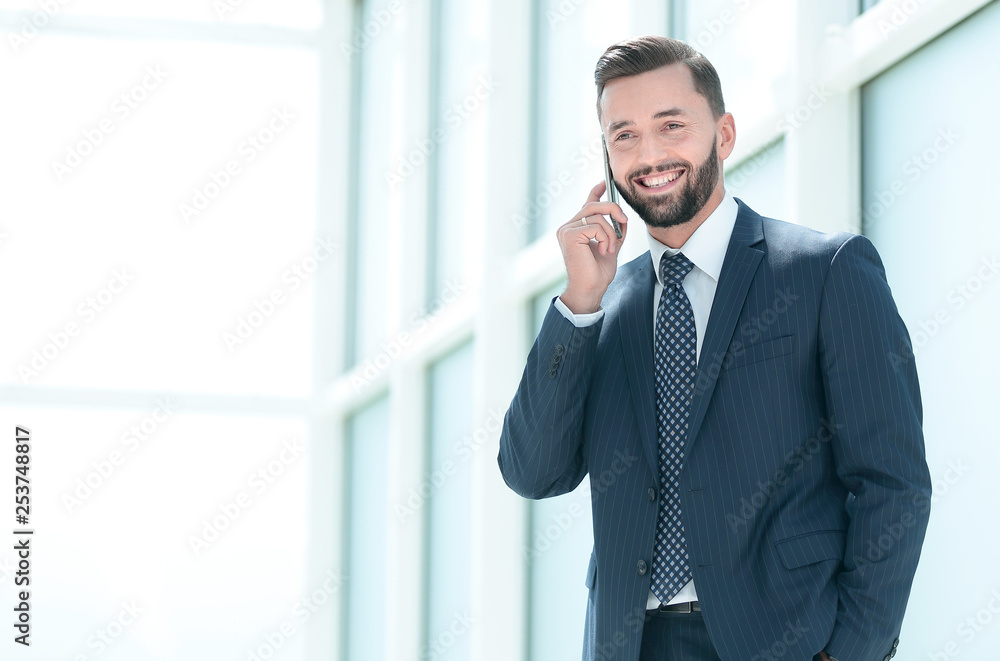 close up.smiling businessman talking on the phone close up.smiling businessman talking on the phone