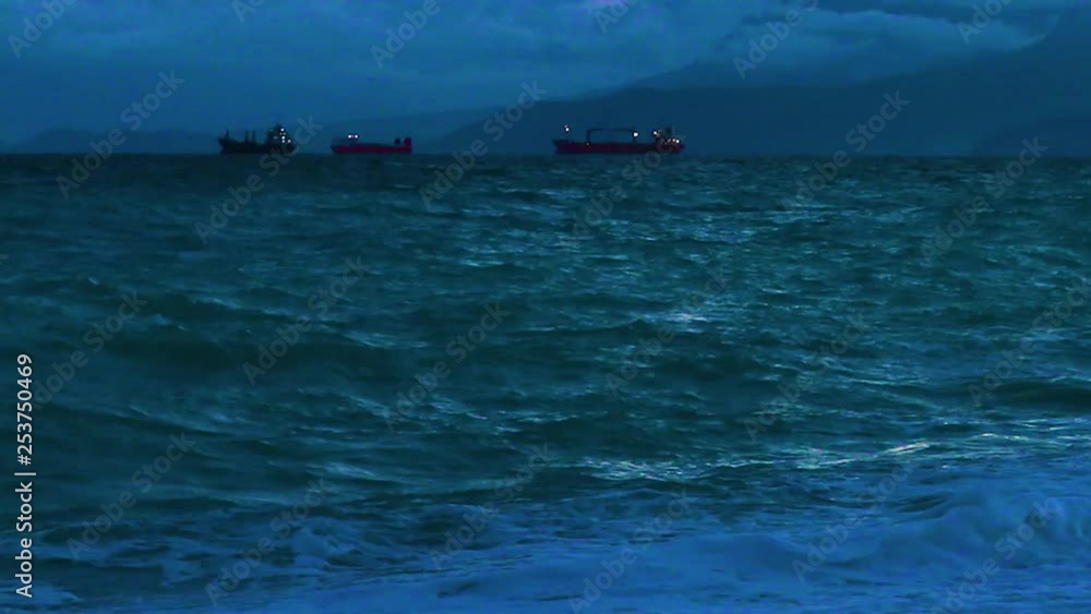 Ships are waiting on the sea at sunset to drop their products off to the dock. Timelapse Ships are waiting on the sea at sunset to drop their products off to the dock. Timelapse