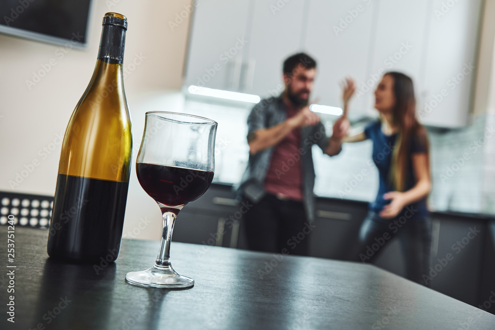 Addiction denied is recovery delayed. Family of alcoholics. Couple having an argument in the kitchen Addiction denied is recovery delayed. Family of alcoholics. Couple having an argument in the kitchen