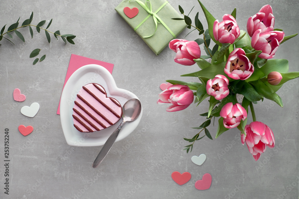 Pink heart ice cream on ceramic plate and bunch of pink tulips Pink heart ice cream on ceramic plate and bunch of pink tulips
