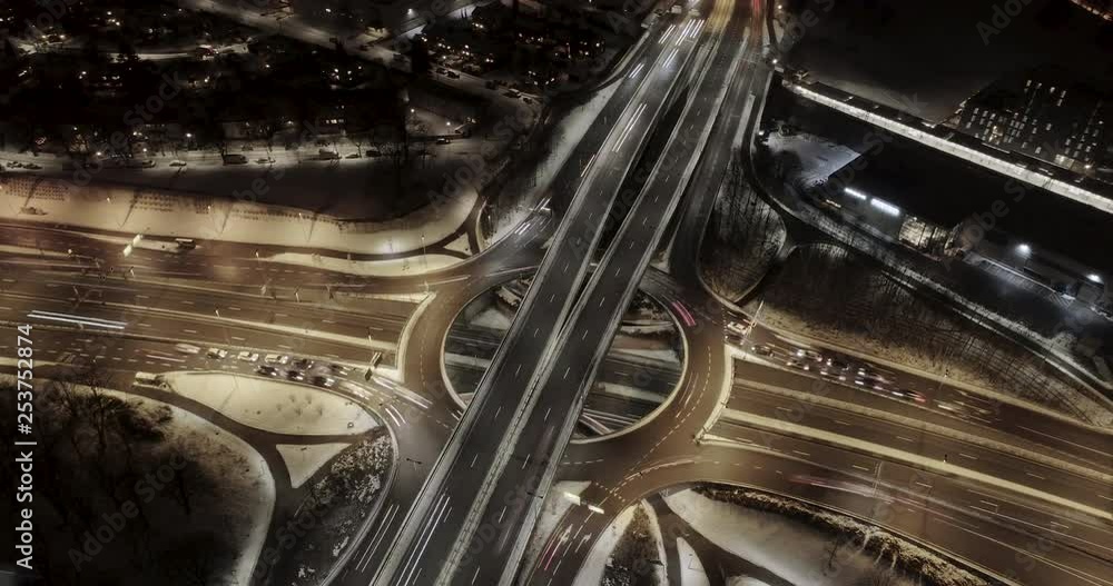 4K high angle aerial view hyperlapse of night traffic on busy freeway with 4 way intersection and circle roundabout in Oslo city, Norway. 4K high angle aerial view hyperlapse of night traffic on busy freeway with 4 way intersection and circle roundabout in Oslo city, Norway.