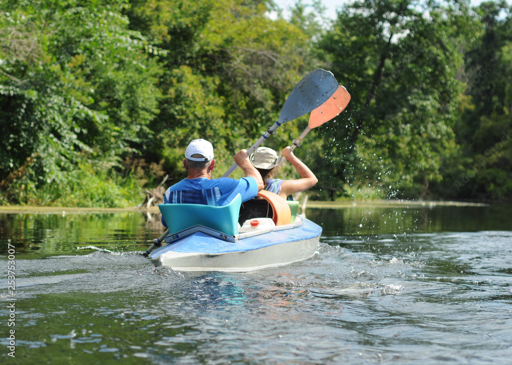 People canoe in a river