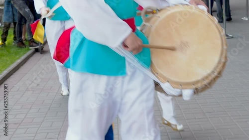 Korean national festival. A group of musicians and dancers in bright colored suits perform traditional Korean folk dance Samul nori Samullori or Pungmul and play percussion Korean musical instruments