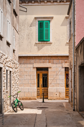 Street with green bicycle and window shutters  Vela Luka  island of Korcula  Croatia