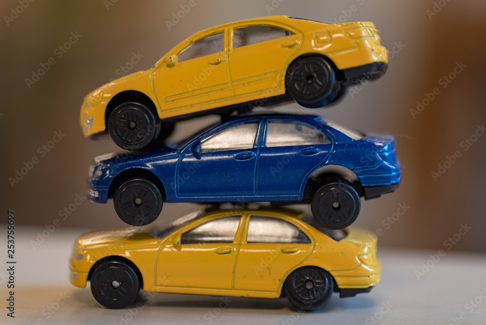 three toy cars in yellow and blue