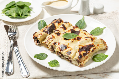 Cannelloni with minced beef and spinach baked in béchamel sauce. 