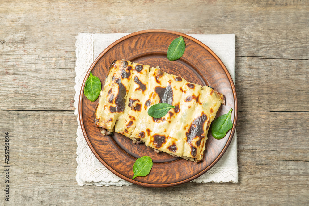 Cannelloni with minced beef and spinach baked in béchamel sauce. The view from the top. Copy-space. Cannelloni with minced beef and spinach baked in béchamel sauce. The view from the top. Copy-space.
