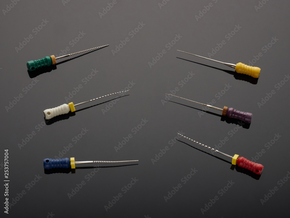 Dental tools for the removal nerves on a gray background with a gradient