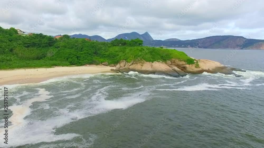 Drone flying forwards at Rio de Janeiro, by the beach, with waves, buildings, mountains - summer season beautiful landscape. Drone flying forwards at Rio de Janeiro, by the beach, with waves, buildings, mountains - summer season beautiful landscape.