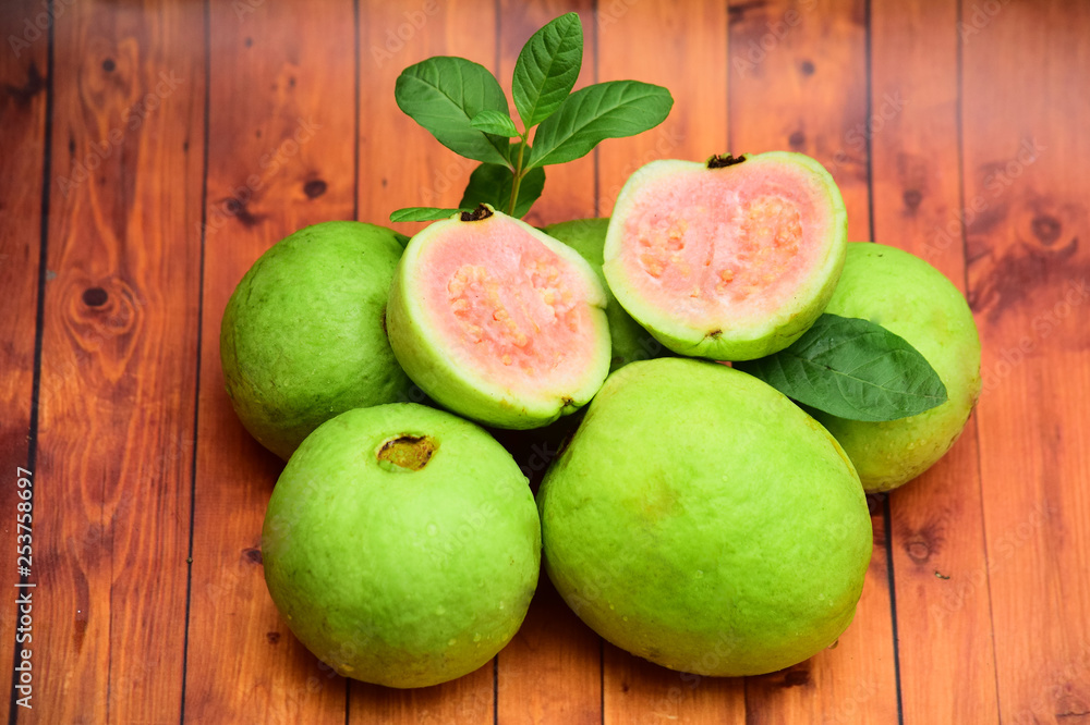guava - fresh guava fruit with a wooden background guava - fresh guava fruit with a wooden background