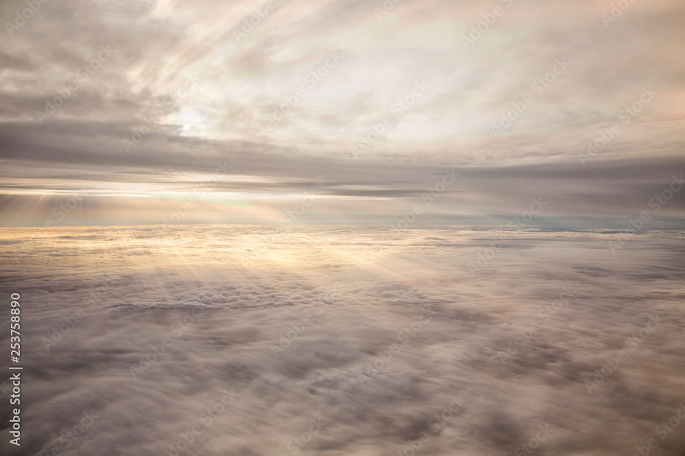 Clouds and sky as seen through window of an aircraft Clouds and sky as seen through window of an aircraft