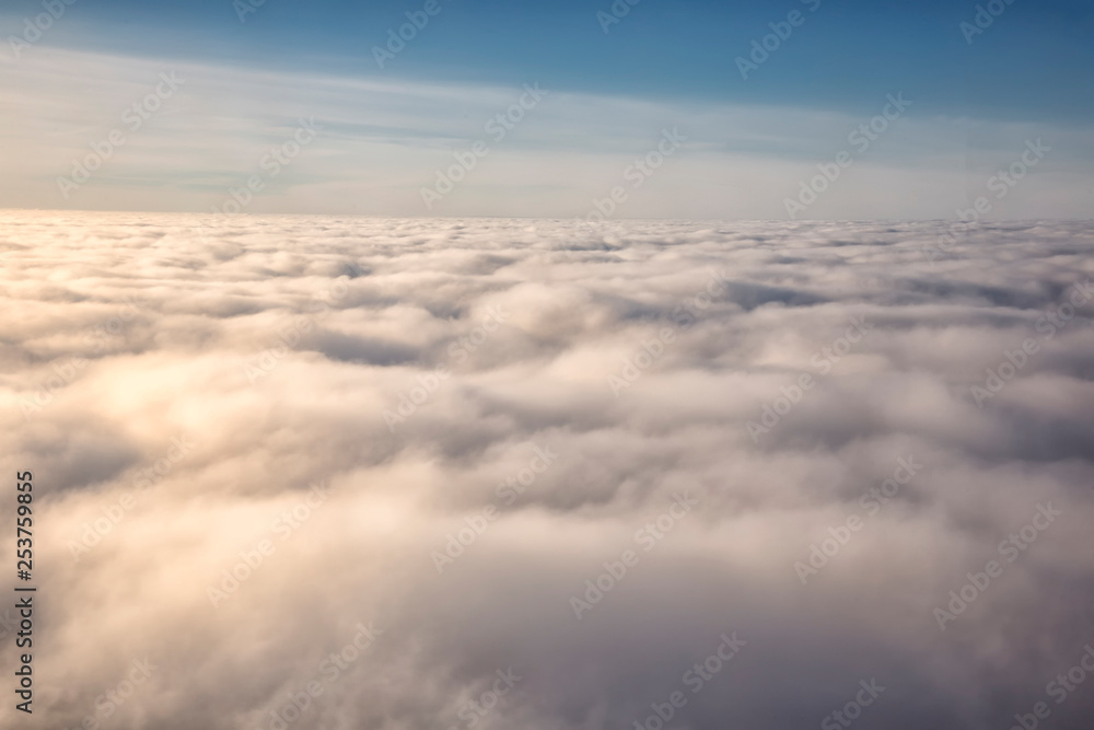 Clouds and sky as seen through window of an aircraft Clouds and sky as seen through window of an aircraft