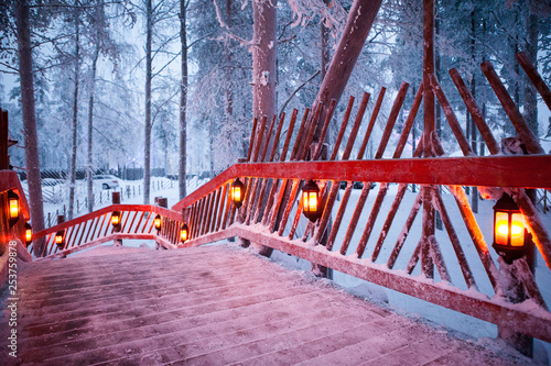 Santa claus village lapland finland. beautiful wooden bridge with lanterns