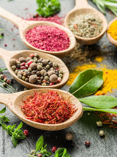 Fototapeta Naklejka Na Ścianę i Meble -  Assortment of colorful spices in the wooden spoons.