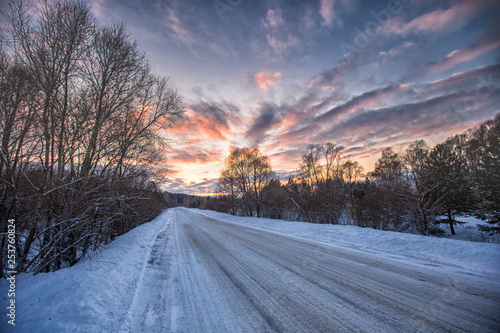 Beautiful road in a snowy winter evening © Venera