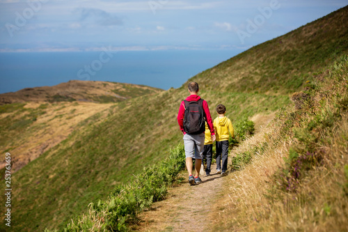 Photos Father and sons, hiking in a beautiful nature of North Devon on a sunny day