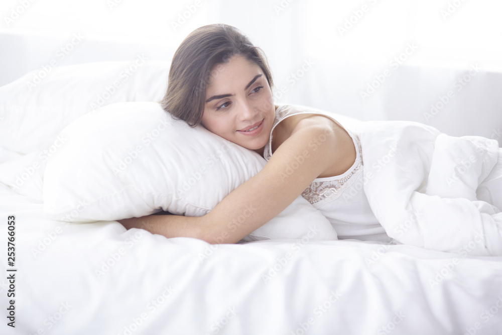 beautiful young woman basking in bed in the morning. Beautiful Model face looks sexy in camera beautiful young woman basking in bed in the morning. Beautiful Model face looks sexy in camera