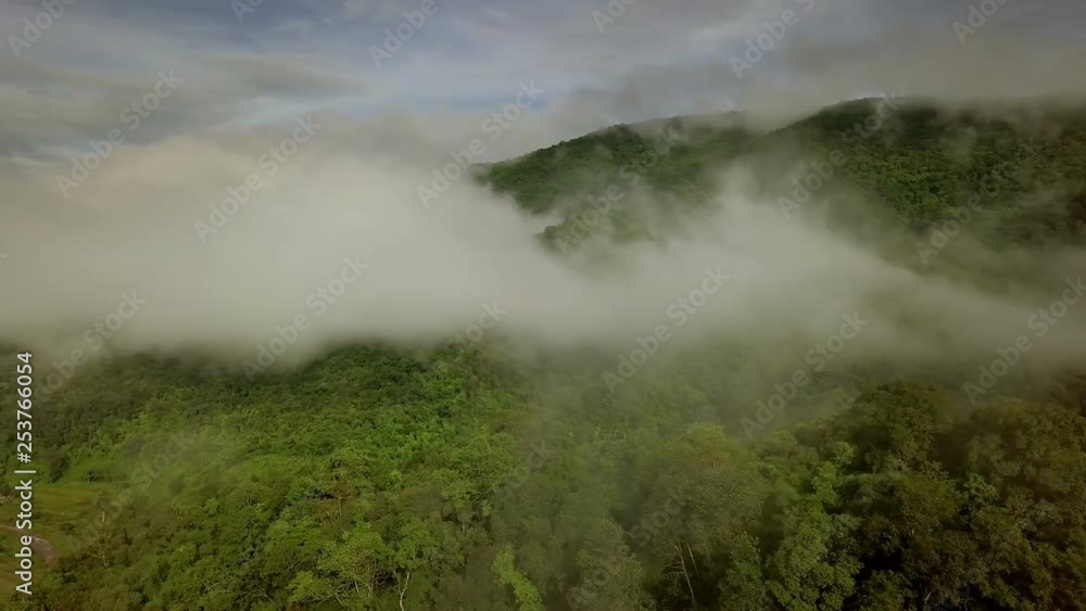 Aerial view flying above lush green tropical rain forest mountain with rain cloud cover during the rainy season on the Doi Phuka Mountain reserved national park the northern Thailand Aerial view flying above lush green tropical rain forest mountain with rain cloud cover during the rainy season on the Doi Phuka Mountain reserved national park the northern Thailand