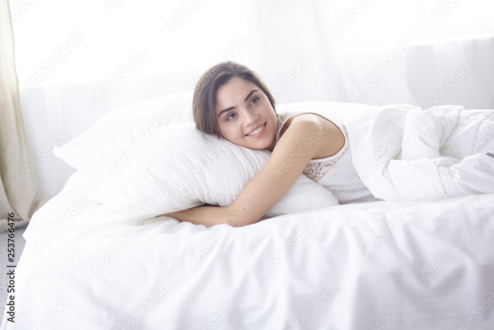 beautiful young woman basking in bed in the morning. Beautiful Model face looks sexy in camera beautiful young woman basking in bed in the morning. Beautiful Model face looks sexy in camera