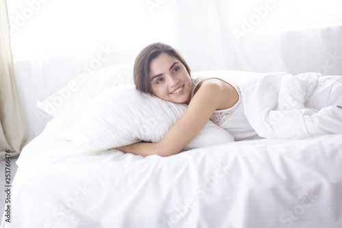 beautiful young woman basking in bed in the morning. Beautiful Model face looks sexy in camera © lenetsnikolai