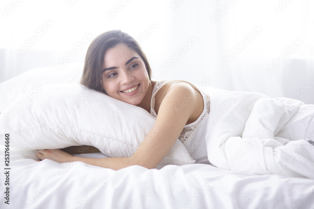 beautiful young woman basking in bed in the morning. Beautiful Model face looks sexy in camera beautiful young woman basking in bed in the morning. Beautiful Model face looks sexy in camera