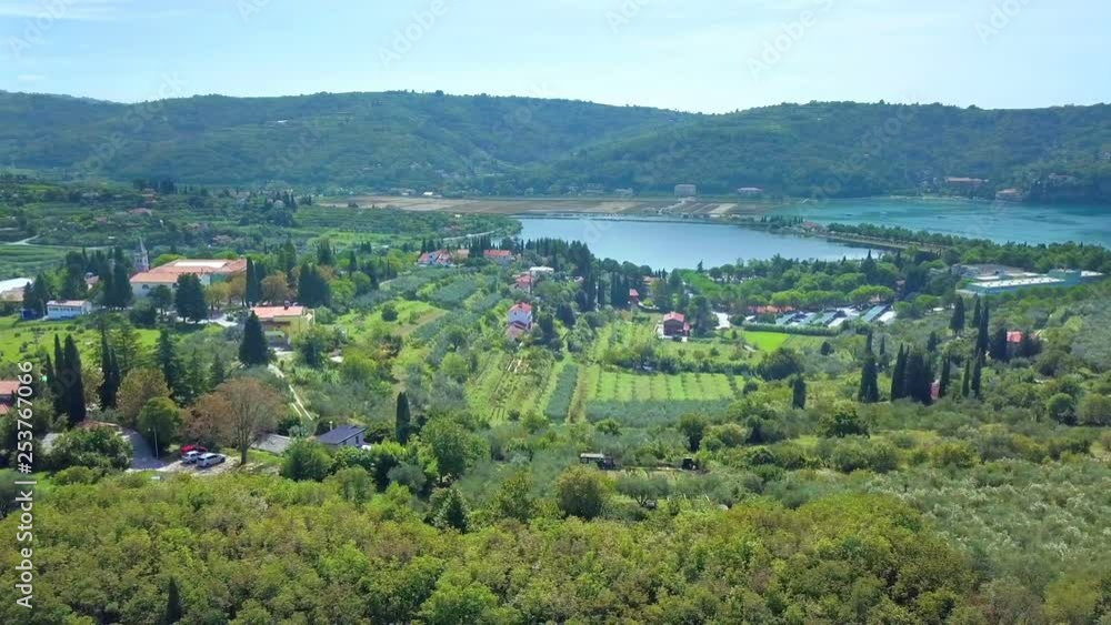 We can see a small town next to the sea. It's a nice day. Nature looks so green and pure in this time of year. We can see a small town next to the sea. It's a nice day. Nature looks so green and pure in this time of year.