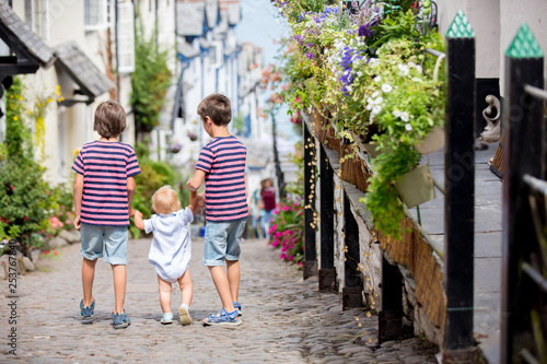 Beautiful family, walking on the streets of Clovelly, nice old village in the heart of Devonshire © Tomsickova