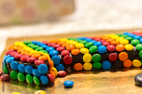 Birthday cake covered colourful candies 