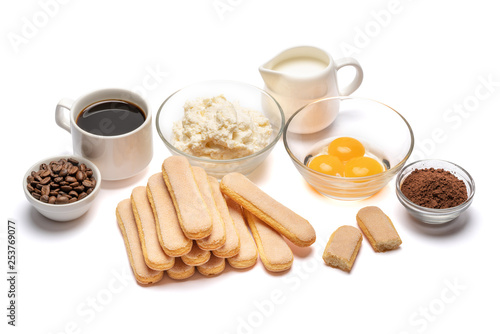 Ingredients for cooking tiramisu Savoiardi biscuit cookies, mascarpone, cream, sugar, cocoa, coffee and egg isolated on white background. Clipping path