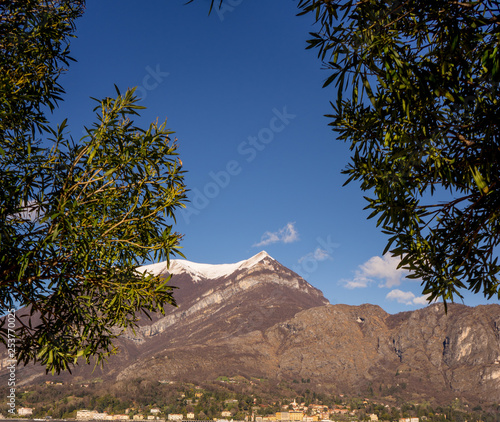 Italy, Bellagio, Lake Como, Cadenabbia, SCENIC VIEW OF MOUNTAINS AGAINST BLUE SKY photo