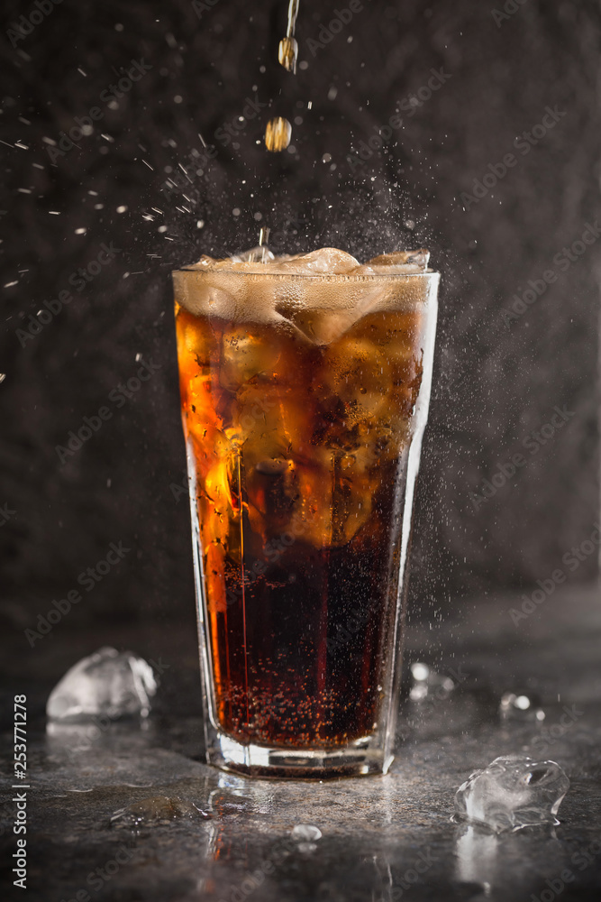 Glass of coke with ice on a dark background. Carbonated beverages. Selective fokus. Glass of coke with ice on a dark background. Carbonated beverages. Selective fokus.