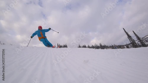 skier makes a turn on the slope, after the snowcat. the corduroy pattern on the snow slope. carving on mountain skiing. close-up of the skier. the sky at dawn with clouds. stock video footage
