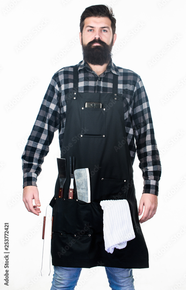 Becoming a professional chef. Barbecue master class at grill restaurant. Confident grill master in working uniform. Master chef wearing grill apron with barbecue tools. Master of grill Becoming a professional chef. Barbecue master class at grill restaurant. Confident grill master in working uniform. Master chef wearing grill apron with barbecue tools. Master of grill