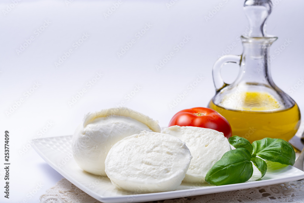 Soft white Italian cheese Mozzarella buffalo served with fresh tomato, olive oil and green basil leaves