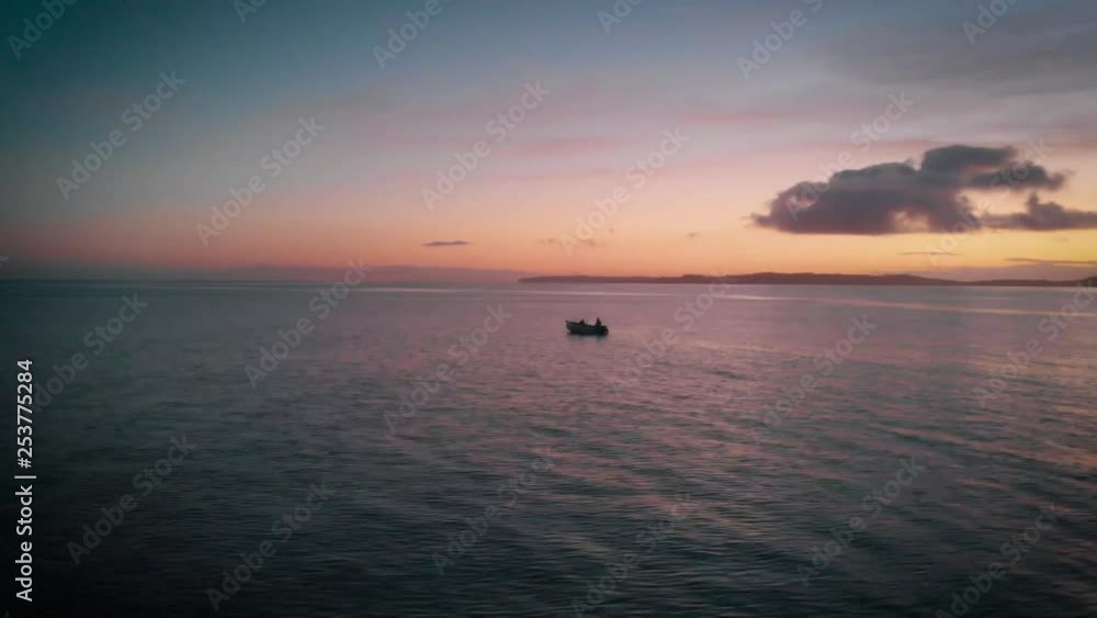 Row boat out at sea during sunset in New Zealand Row boat out at sea during sunset in New Zealand